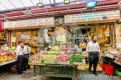 Jerusalem, Israel- August 16, 2016: Men shopping for vegetables in a market in Jerusalem, Israel Editorial Stock Photo