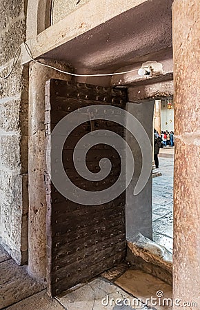 Iron-bound church side door to the Church of Nativity in Bethlehem in Palestine Editorial Stock Photo