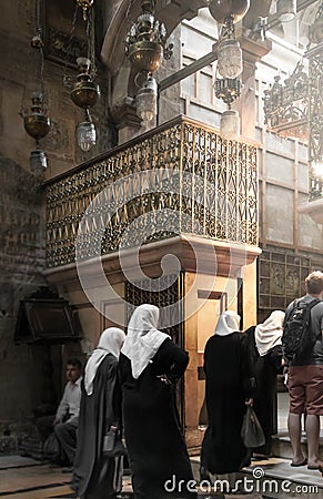 Believing women in white headscarves and in black clothes praying inside the Church of the Holy Sepulcher Temple of the Resurrec Editorial Stock Photo