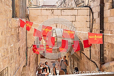 Decoration in red flags with Armenian symbols hanging on ropes on the quiet small Ararat Street in the Armenian quarter in the old Editorial Stock Photo