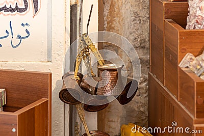 Copper turks for coffee brewing are sold in the shop on the Arab market on Al-Qattanin street in the Arab Quarter in the old city Editorial Stock Photo