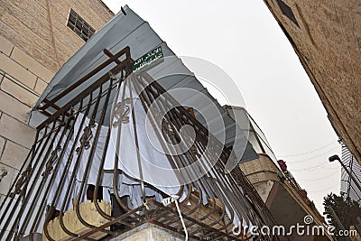 Jerusalem Israel 27 March 2021, balcony of a residential building with bars and awning, white linen drying Editorial Stock Photo