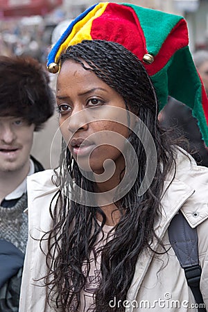 JERUSALEM, ISRAEL - MARCH 15, 2006: Purim carnival, portrait of a young Ethiopian woman on her head wearing clown hat with bells. Editorial Stock Photo