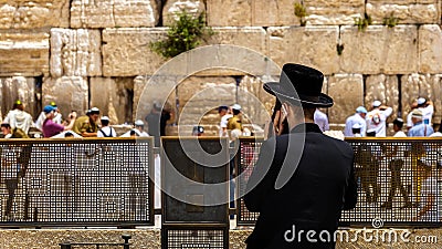 An Orthodox Jew uses a cell phone in front of the Western Wall in Jerusalem Editorial Stock Photo