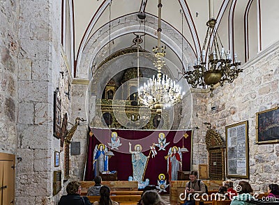 The guide tells visitors about St. Mark`s Church - The Syrian Orthodox Church in old city of Jerusalem, Israel Editorial Stock Photo