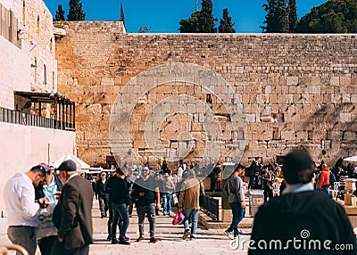 Jerusalem western wall with people. Cityscape image of Jerusalem. View of prayers, wishes and prays. Editorial Stock Photo