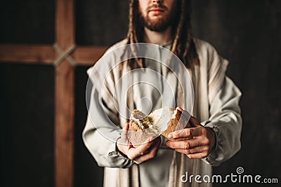 Jesus Christ gives bread to faithful, sacred food Stock Photo