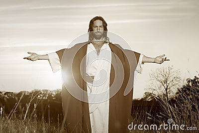 Jesus Christ Arms Outstretched in Light Stock Photo