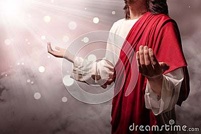 Jesus christ raised hands and praying to god with ray Stock Photo