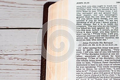 Jesus Christ's betrayal, biblical verses in open holy bible book on wooden table Stock Photo
