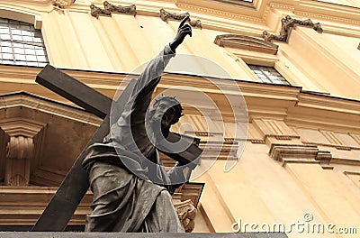 Jesus Christ statue with cross and pointing hand finger against cathedral building in Warsaw, Poland. Stock Photo