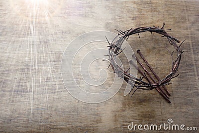 Jesus Crown Thorns and nails on Old and Grunge Wood Background. Vintage Retro Style. Free space for text Stock Photo