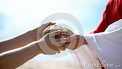 Jesus hands giving bread to poor man, biblical story to feed hungry, charity Stock Photo