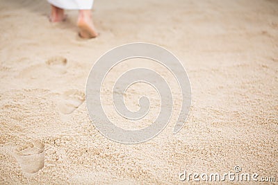 Jesus leaving footprints in sand Stock Photo