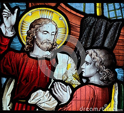 Jesus pointing to heaven. Stained glass window iconography Stock Photo