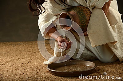 Jesus pouring water from a jar Stock Photo