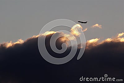 Jet airliner flies above the clouds Stock Photo