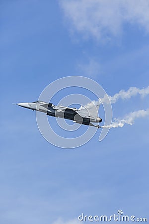 Jet fighter flying with white smoke Stock Photo