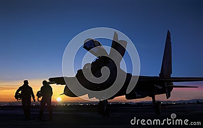 Jet fighter pilot walking during sunset at air force base airfield Stock Photo
