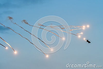 Jet military plane MIG 21 launching rockets flares at an Airshow Stock Photo