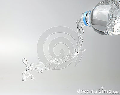 A jet of sparkling water escaping from the bottle. Stock Photo
