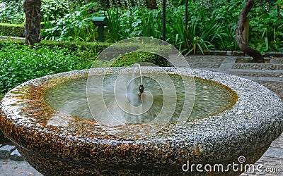 Jet stream of stone fountain drinking water Stock Photo