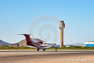 Jet on Taxiway under control tower Stock Photo