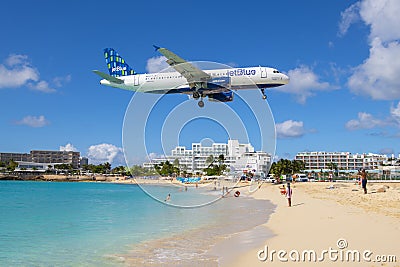 Airplane flying over Maho Beach, Sint Maarten, Dutch Caribbean Editorial Stock Photo