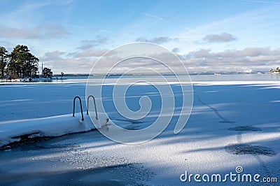 Jetty with ladder covered in snow Motala Sweden Stock Photo