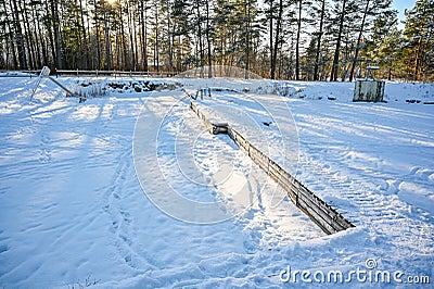 jetty and ladder in a lake covered in ice and snow Stock Photo