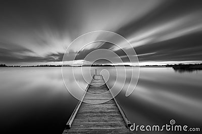 Jetty on a lake in black and white Stock Photo
