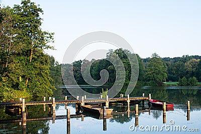 Jetty with rowing boats at the first rays of sunshine. Stock Photo