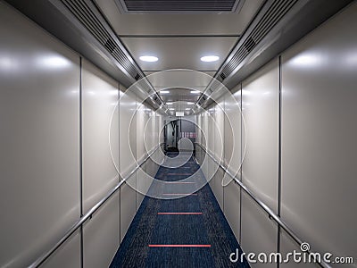 Jetway, walking towards the plane on carpet, seeing the plane door. perspective aerobridge corridor to aircraft. Editorial Stock Photo