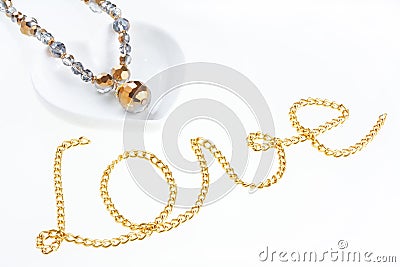 Jewel necklace on heart shaped saucer and chain Stock Photo