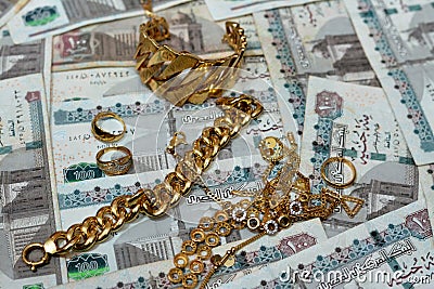 Jewellery or jewelry with EGP LE Egyptian pounds cash money banknotes, brooches, rings, necklaces, earrings, pendants, bracelets, Stock Photo