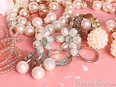 Jewelry background , gold white pearl rings earrings bracelet on pink background with blue gemstones ,jewelr women accessorie Stock Photo