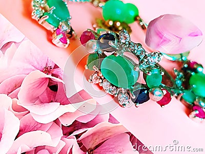 Jewelry green emerald silver pink opal costume jewelry for women on living coral background Stock Photo