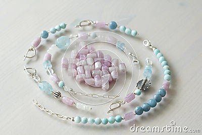 Jewelry made of natural stones and silver. Aquamarine, larimar, kunzite, moonstone. Handmade. Asymmetric jewelry. Asymmetry. Stock Photo