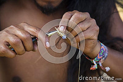 Jewelry maker hands creating earrings from metal string Stock Photo