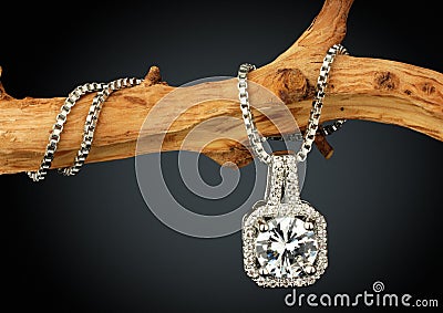 Jewelry pendant with big diamond on twig, on dark background Stock Photo