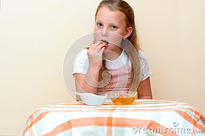Jewish child dipping apple slices into honey on Rosh HaShanah. Stock Photo