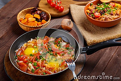 Jewish food cholent and shpkshuka on a laid Shabbat table. Stock Photo