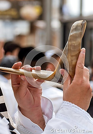 Jewish hasid blows Shofar. Hands and shofar close-up Stock Photo