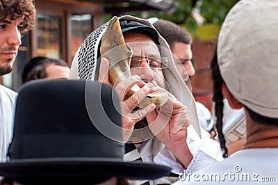 Jewish hasid blows Shofar. Rosh Hashanah, Jewish New Year. Editorial Stock Photo