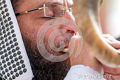 Jewish hasid blows Shofar. Rosh Hashanah, Jewish New Year. Editorial Stock Photo