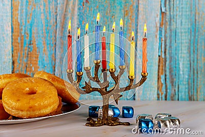 Jewish holiday Hanukkah with menora, donuts and dreidels Stock Photo
