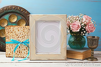 Jewish holiday Passover Pesah concept with poster photo frame, matzoh and rose flowers bouquet Stock Photo