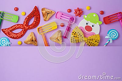 Jewish holiday Purim background with cute paper clowns character, hamantaschen cookies and carnival mask Stock Photo