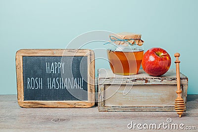 Jewish holiday Rosh Hashana background with chalkboard, honey jar and apple Stock Photo