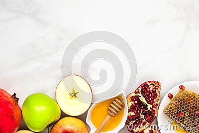 Jewish holiday Rosh Hashana background with honey, pomegranate and apples on white marble table. flat lay Stock Photo